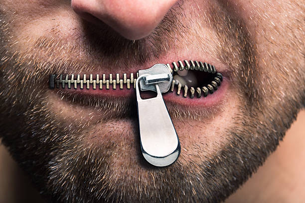 Zipped mouth Insubordinate man with zipped mouth censorship photos stock pictures, royalty-free photos & images