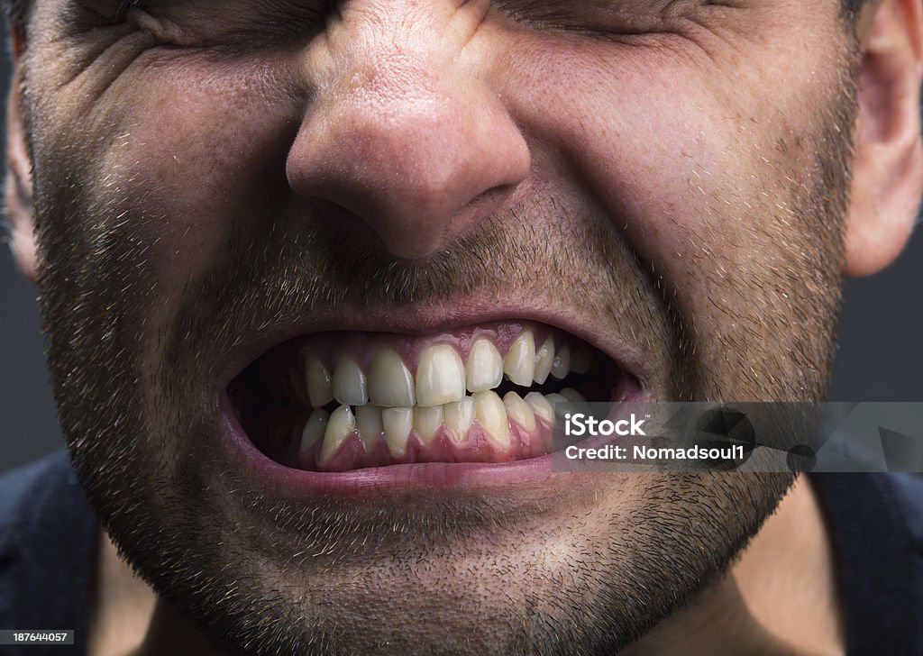 Stress Closeup of mouth of very stressed man Grinding Stock Photo