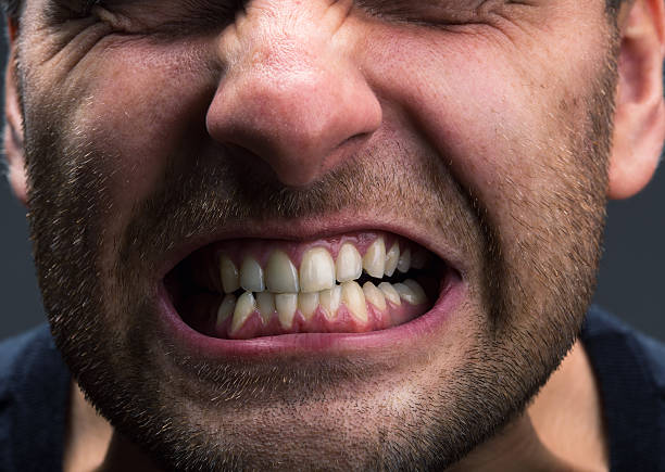 Stress Closeup of mouth of very stressed man grinding stock pictures, royalty-free photos & images