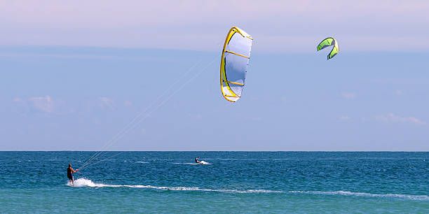 Kiteboarding Kiteboarding off the coast of Florida. kiteboarding stock pictures, royalty-free photos & images