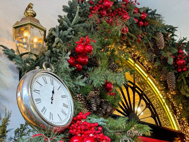 istock Beautiful Christmas tree and New Year decorations and golden clock on facade. 1876467011