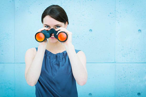 istock Businesswoman holding binoculars 187647482