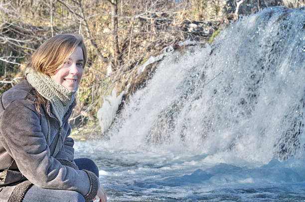 istock Woman by waterfall in winter 187647989