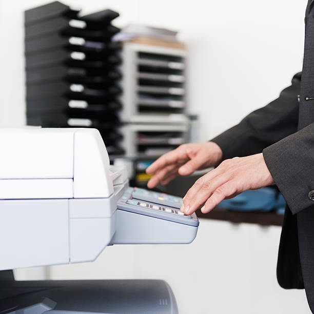 istock Businessman Using Photocopier 187648318