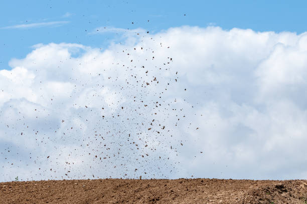 istock Debris fly after motocross roaring against cloudy sky. 1876512121