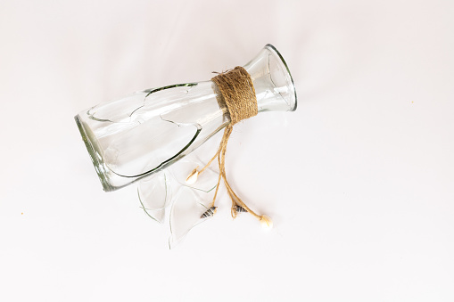 Transparent decorative glass vase shattered on white isolated background