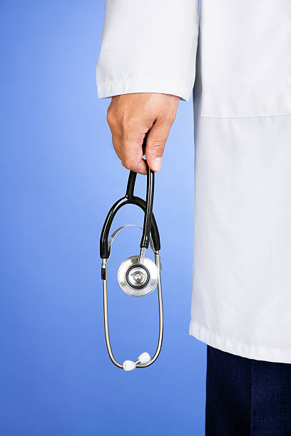 istock Male doctor holding stethoscope 187653515
