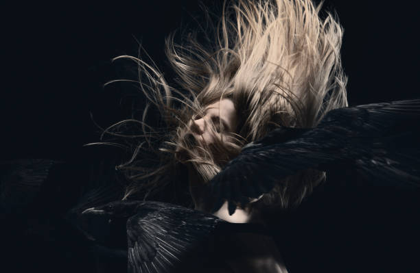 istock Young woman in motion with flying ravens 1876567291