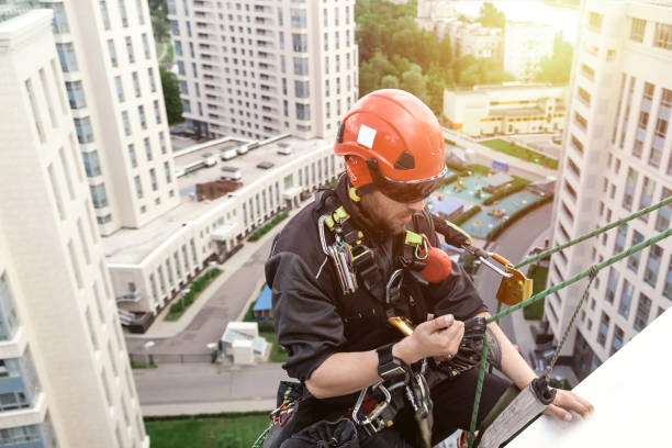 istock Industrial mountaineering worker hangs over residential facade 1876608606