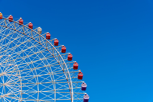 Ferris wheel, colorful big wheel on blue sky. Tempozan ferris wheel Osaka city Japan.