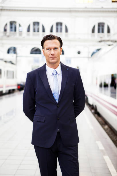 istock Businessman waiting at train station 187662170