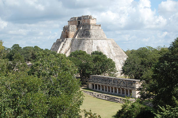 Uxmal Pyramid of the Magician and Colonnade Yucatan Peninsula Mexico Pyramid of the Magician and Colonnade Structure at Uxmal Archeological Site in the Puuc Region of the Yucatan Peninsula near Merida, Mexico. uxmal stock pictures, royalty-free photos & images