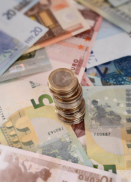 istock euro banknotes and stack of coins isolated 187664336