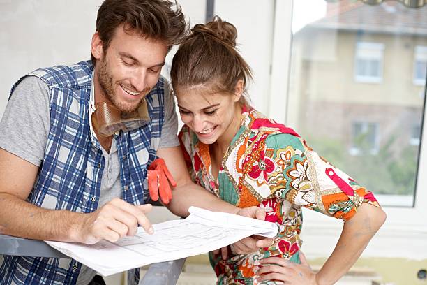 istock Happy man and woman viewing blueprints 187664433