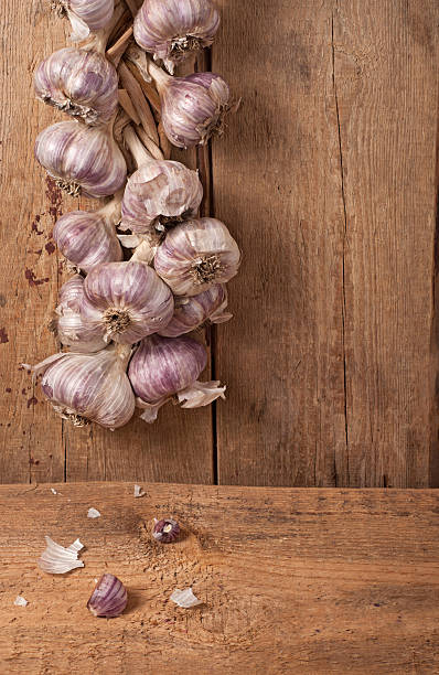 Garlic on wooden background stock photo