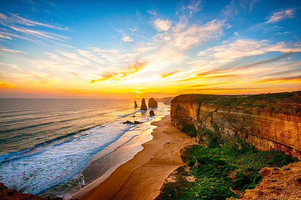 Twelve Apostles The sun sets along the Great Ocean Road  great ocean road photos stock pictures, royalty-free photos & images