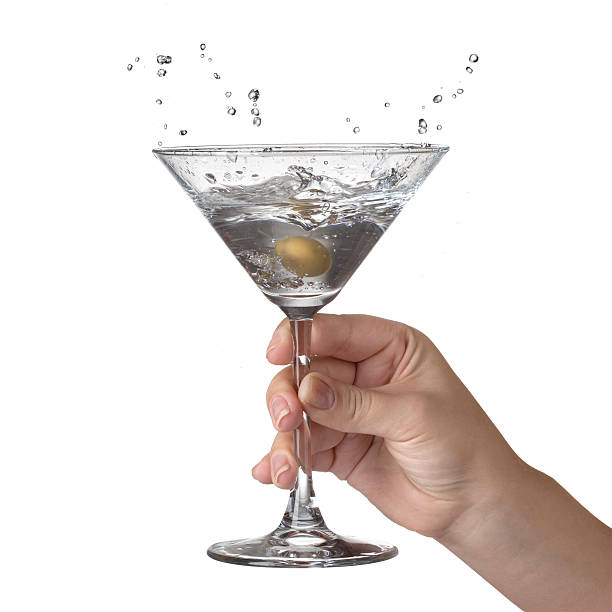 istock Splash of martini in womans hand isolated 187670399