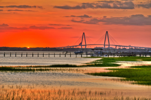 A Sunset overlooking the Charleston harbor from Mount Pleasant with the Arthur Ravenal Bridge in the distance