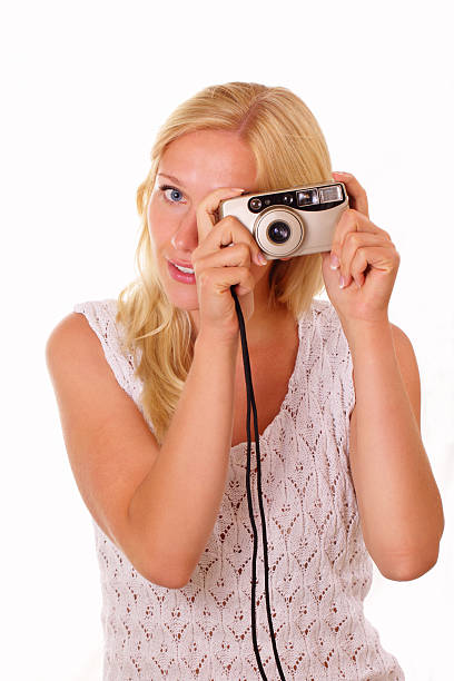 Beautiful young woman with an old camera stock photo