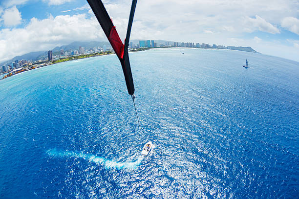 Parasailing Over Ocean in Hawaii Parasailing Over Ocean in Hawaii, View from up in the Sky para ascending stock pictures, royalty-free photos & images