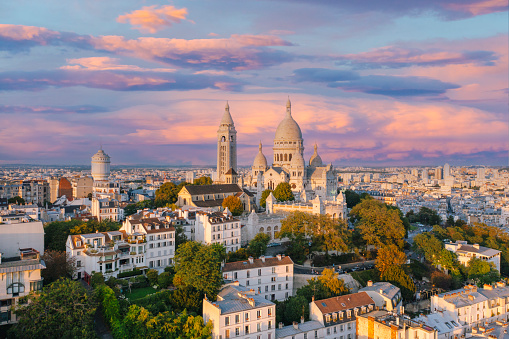 Aerial view of Montmartre hill with Basilique du Sacre-Coeur in Paris during sunset Paris France