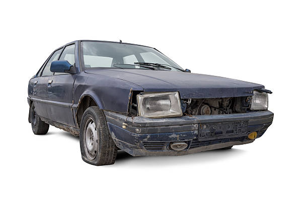 Old and Damaged Car Old and damaged blue car isolated on white background. obsolescence stock pictures, royalty-free photos & images