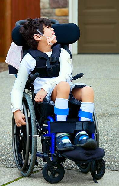 istock Seven year old disabled boy in wheelchair 187679538