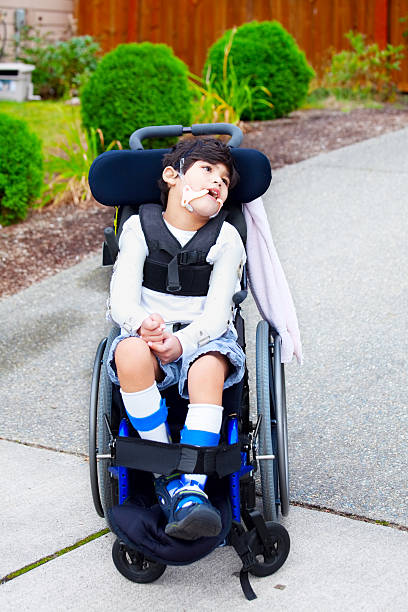 istock Seven year old biracial disabled boy in wheelchair 187679590