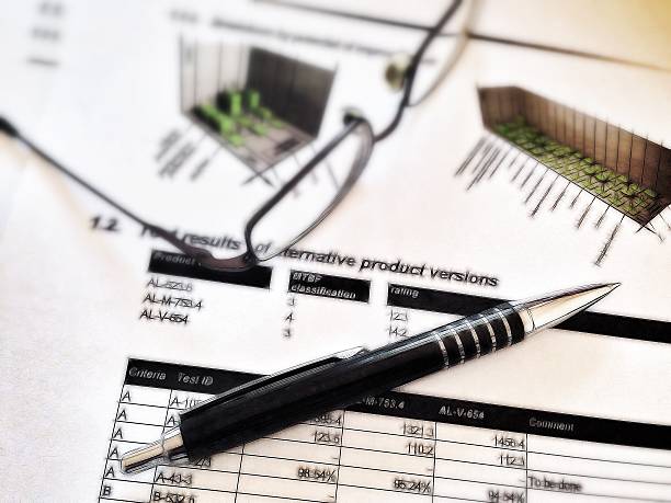 istock pen and glasses laying on a report with statistics 187679984