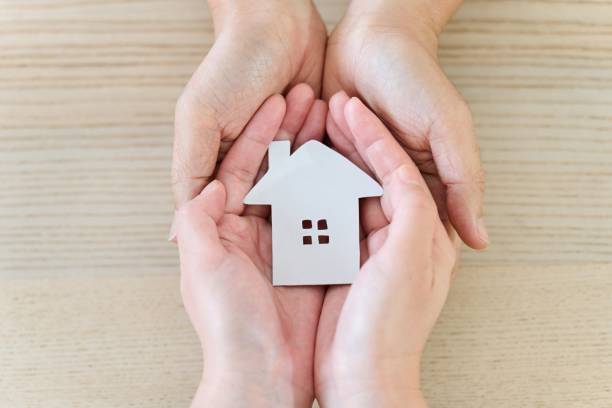 istock Couple's hands wrapping around the house 1876826371