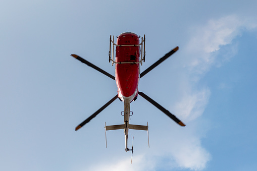 Rescue red helicopter on a background of blue sky.