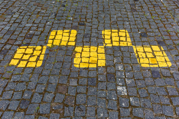 Top view of footpath tiles. Yellow circle buttons pattern. A stop signal for blind person. Solid square background