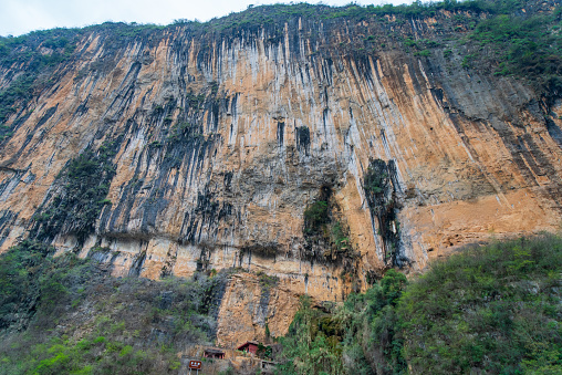 Scenery of the Three Gorges of the Yangtze River, with the Luojiazhai Cliff in the foreground. The cliffs are a dramatic backdrop to the landscape.