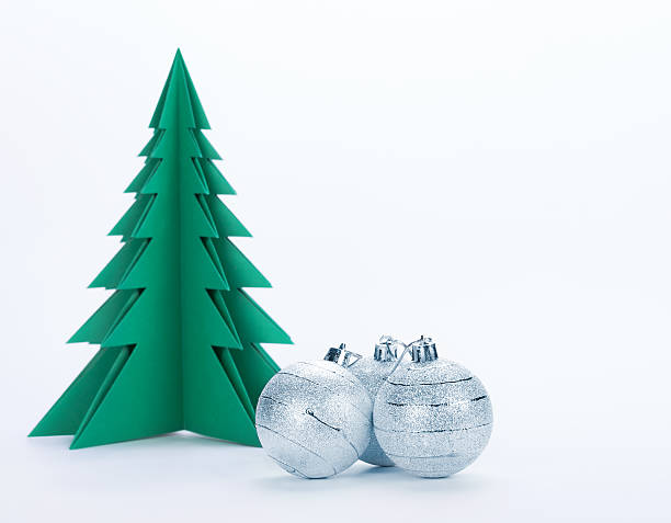 istock Christmas decorations and green paper tree on a white background 187690055