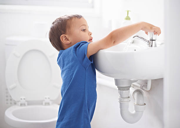 Hygienic habits Shot of a cute young boy washing his hands in a bathroom preschooler caucasian one person part of stock pictures, royalty-free photos & images