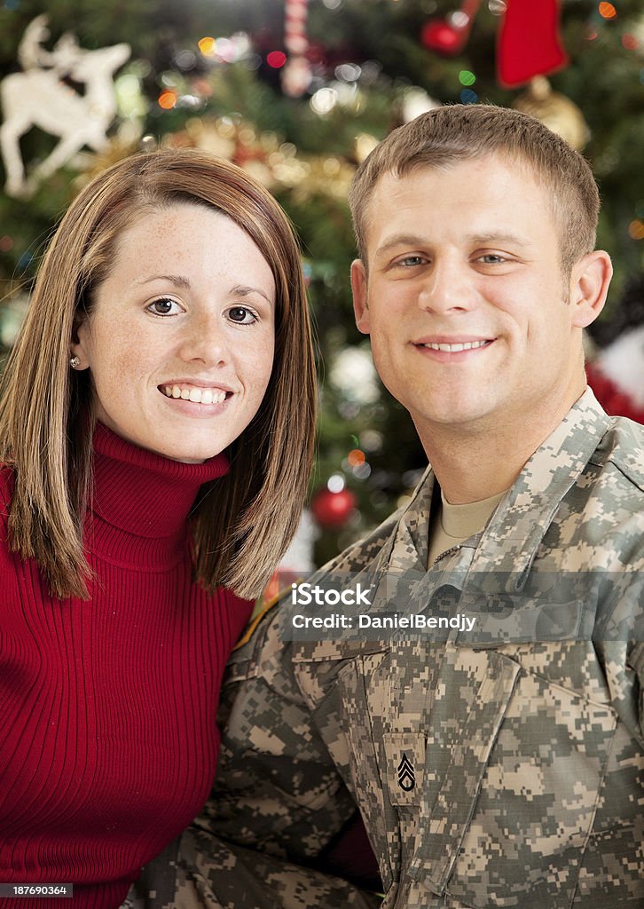 American Soldier & Wife American soldier & wife against Christmas decorations.  Adult Stock Photo