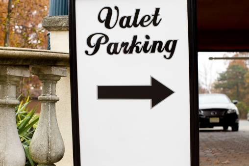 Valet Parking Sign with Car in Background.