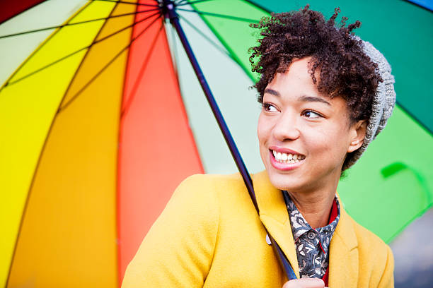 istock Beautiful multi-racial woman with umbrella 187690761