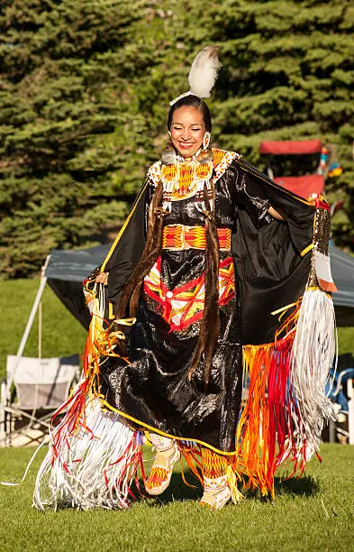 A young Native American woman smiles when she realizes she has won this competition.