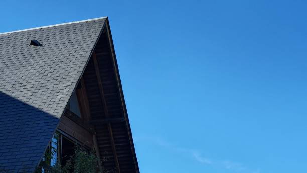 Black slate roof against a blue sky