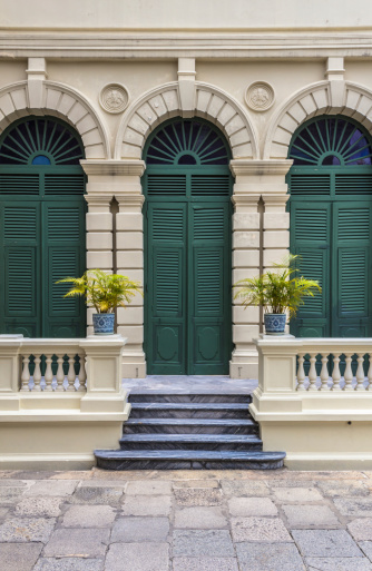 European style green door of old building in Grand Palace ,Bangkok Thailand. This photo is taken at the tourist's exit of Grand Palace.