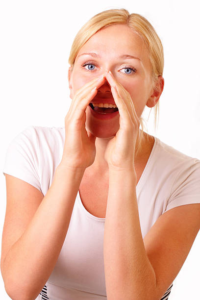 Attractive young blonde woman talking stock photo