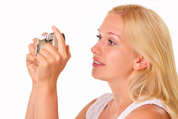 Attractive young woman with an old camera stock photo