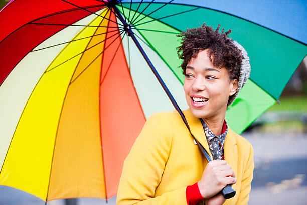 istock Beautiful multi-racial woman with umbrella 187694963
