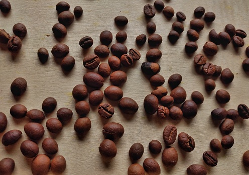 Roasted coffee beans on wooden table
