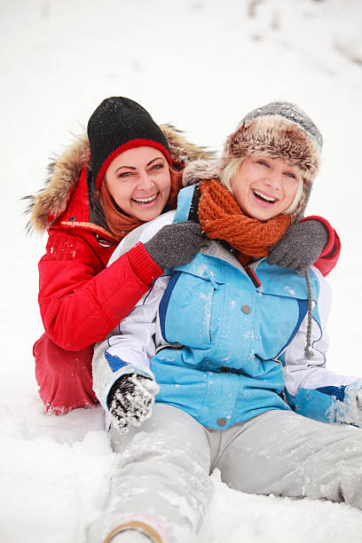 istock Two young woman having fun on snow 187695422