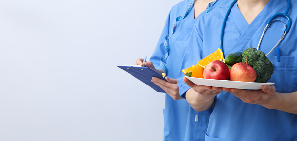 Nurses with clipboard and healthy food - healthy nutrition