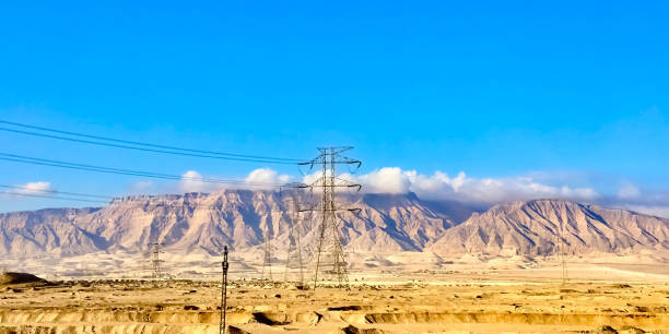 istock Power Lines Electrical Towers and Mountains 1876985864