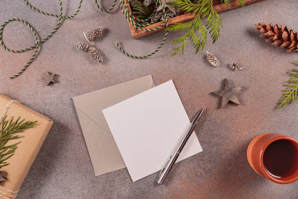 istock Blank postcard with pen, envelope, handmade gift box and Christmas decor 1877010698