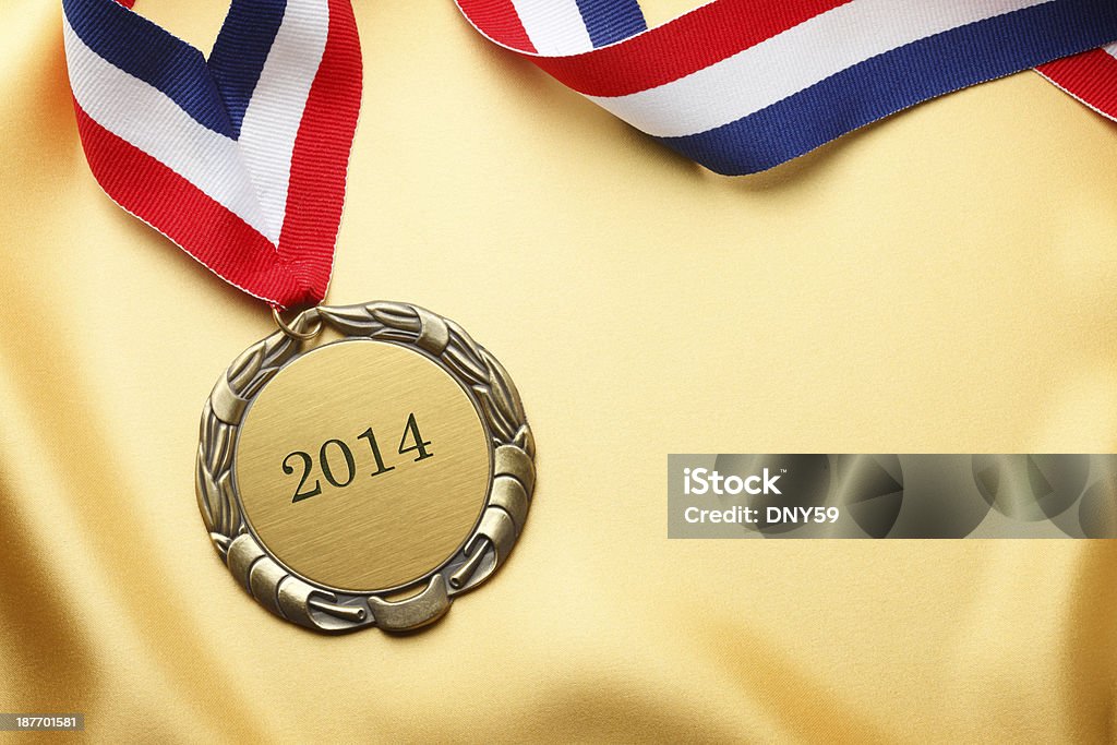 Gold Medal A gold medal on gold satin engraved with 2014. 2014 Stock Photo